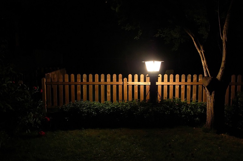 View of Outdoor Lighting with a Single Lamppost in a Yard at Night