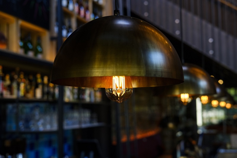 Simple Lighting Changes You Can Make Today Close Up of a Row of Chandeliers in a Bar Setting