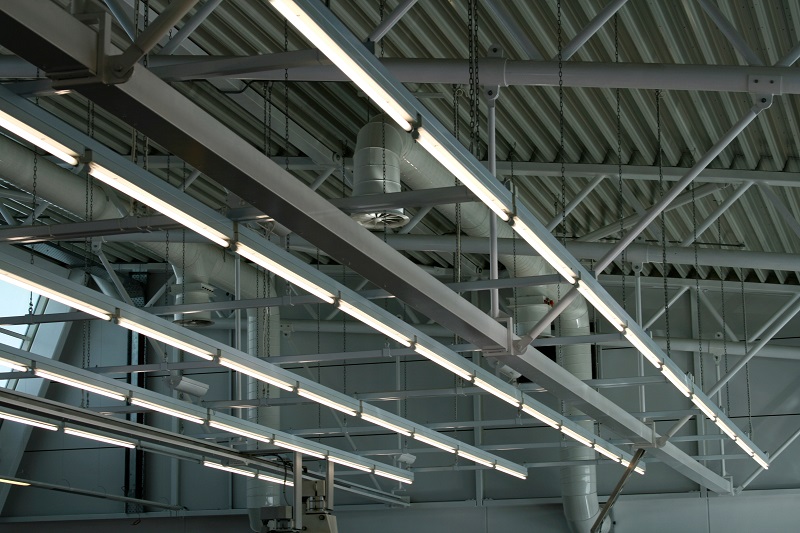 Maxlite Shop Light Overview Fixtures Lined Up along a Ceiling in a Warehouse