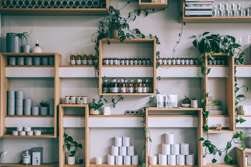 Best Summer Energy Saving Tips Inside of an Apothecary with Products on Wooden Shelves with Hanging Plants